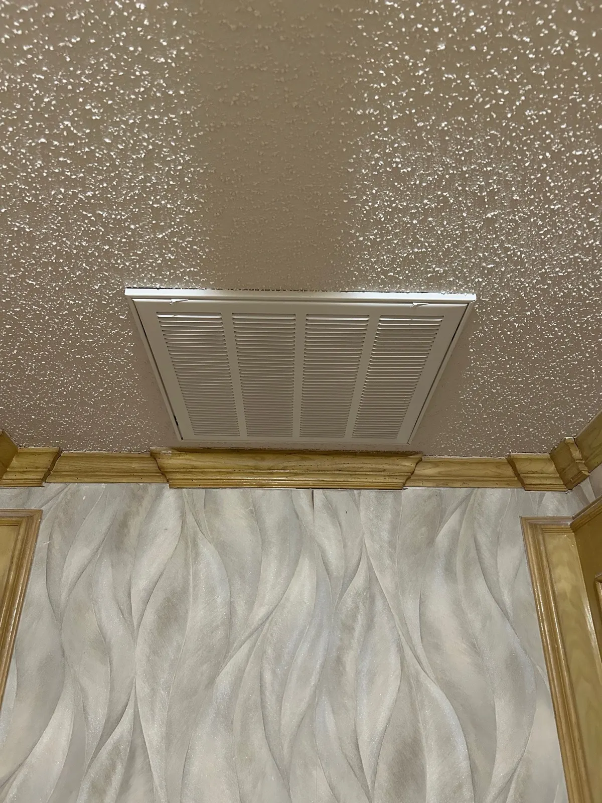 Ceiling after repair — smooth texture finish with clean vent cover